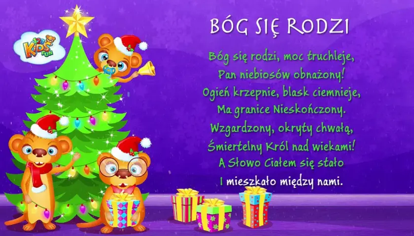 Trzy urocze misie w czapkach Mikołaja przy choince i prezentach. Na ekranie widnieje tekst kolędy "Bóg się rodzi".