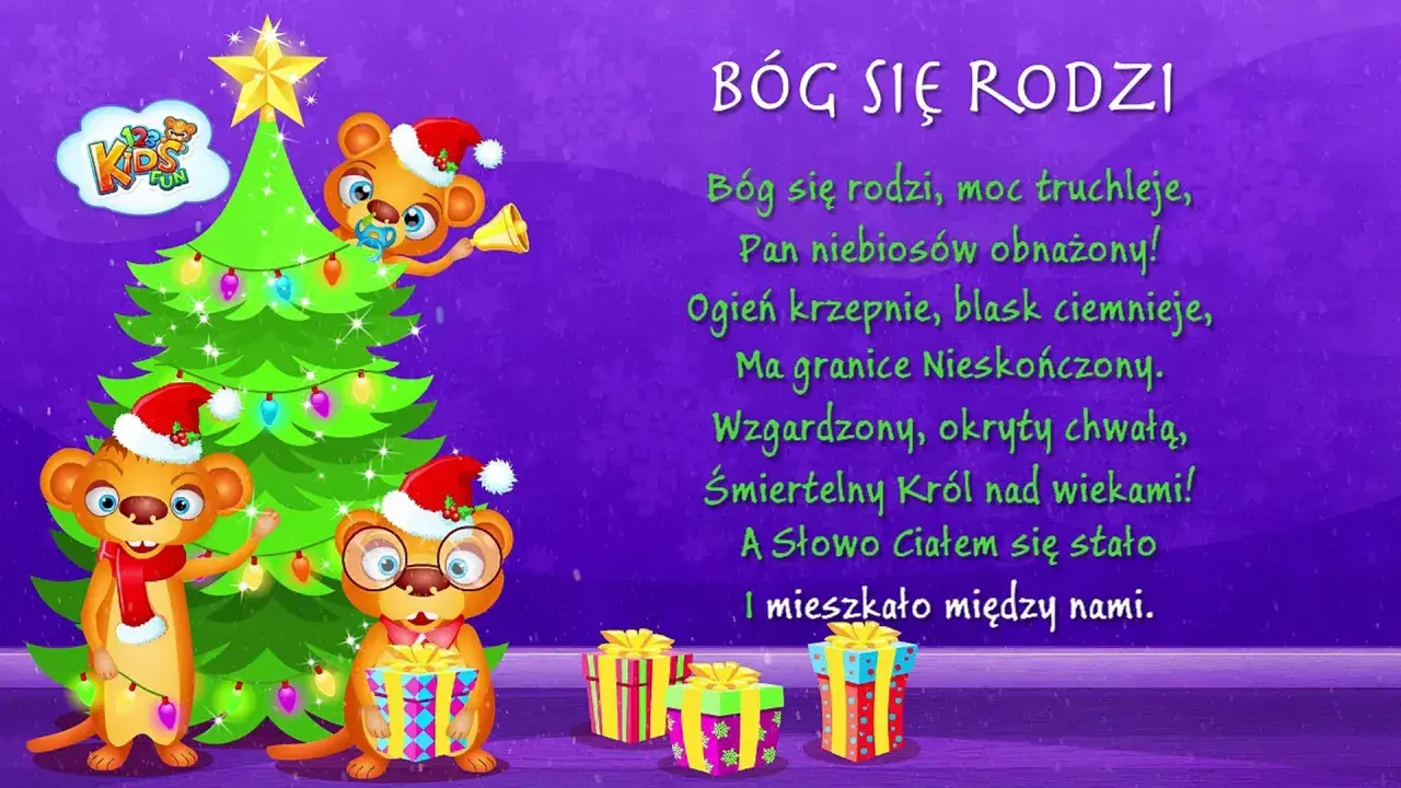 Trzy urocze misie w czapkach Mikołaja przy choince i prezentach. Na ekranie widnieje tekst kolędy "Bóg się rodzi".