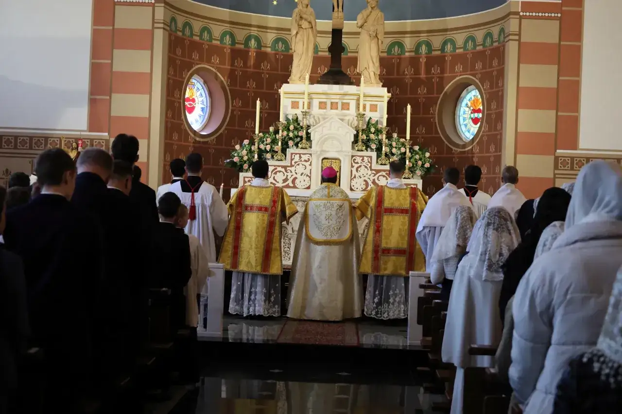 Uroczysta msza święta, podczas której odbywa się bierzmowanie. Widać duchownych w bogatych szatach i wiernych.